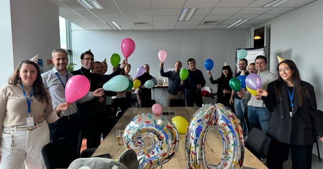 The SensioLabs team celebrating the 20th anniversary of Symfony with balloons