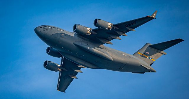 Grey Cargo Plane with a Blue Sky
