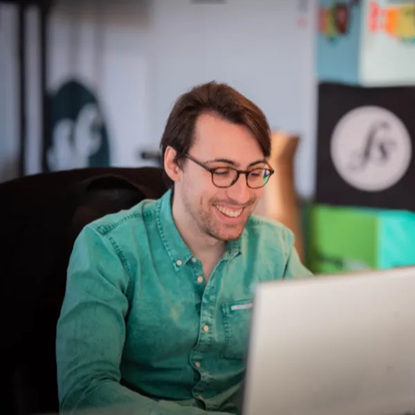 Jules Daunay smiling in a green shirt