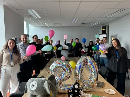The SensioLabs team celebrating the 20th anniversary of Symfony with balloons