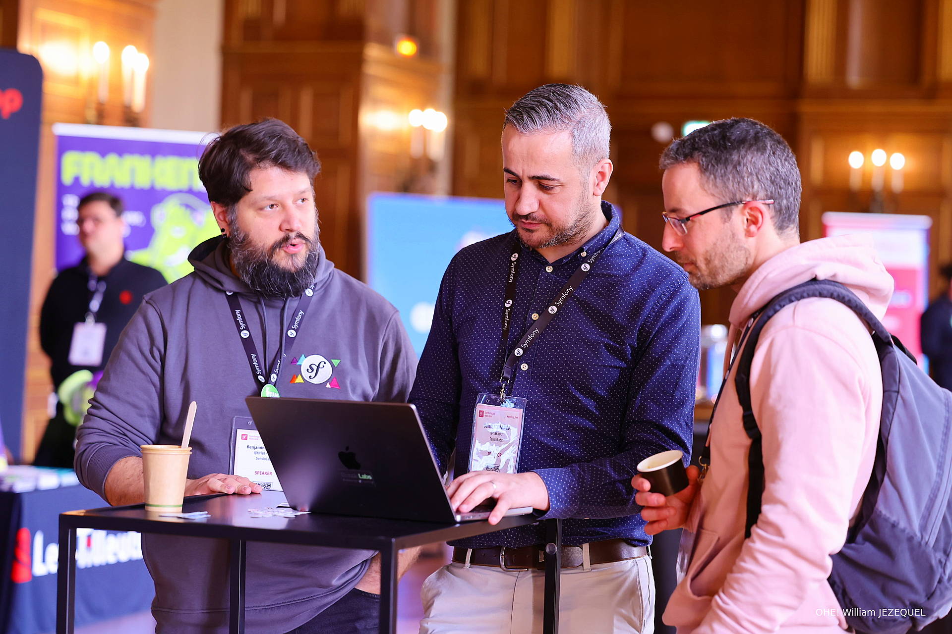 3 developers standing in front of a computer at SymfonyLive Paris 2026