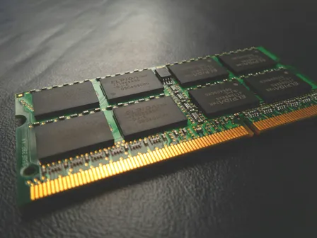 Black green and golden computer RAM on a dark ground