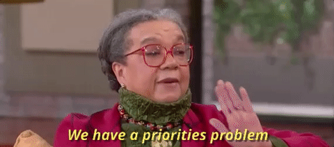 Animated gif with a lady with red glasses talking with the text "We have a priorities problem" below