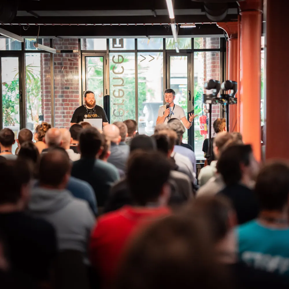 Hubert Lenoir and Jeremy Jarrie standing in front of an audience